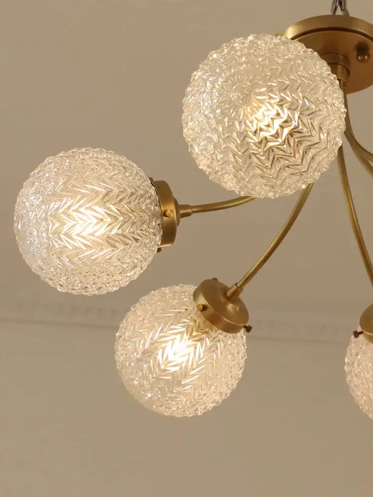DecorBites glass ball ceiling light with three textured clear glass globes and brass metal arms for modern living spaces