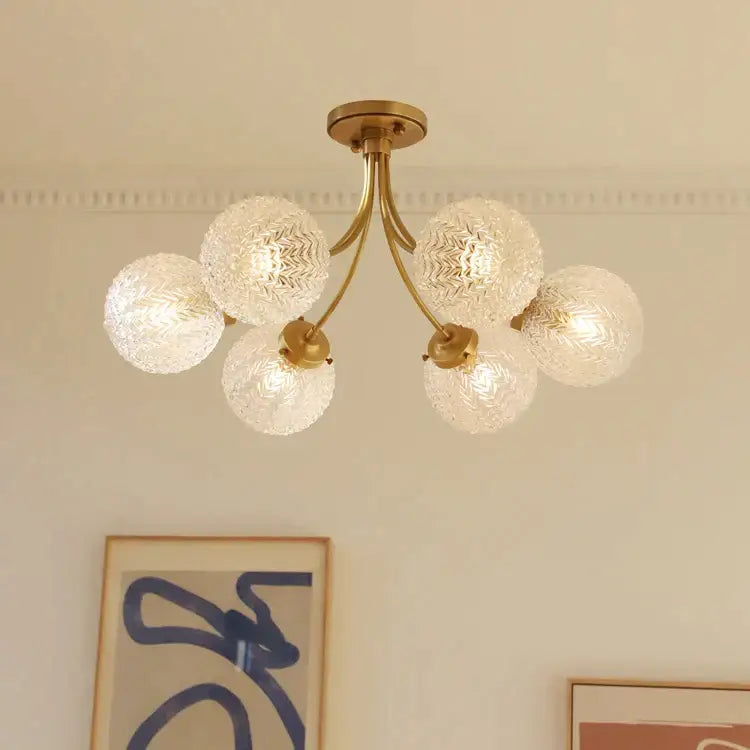 Brass-finished decorbites glass ball ceiling light with five textured clear glass globe shades for modern interiors
