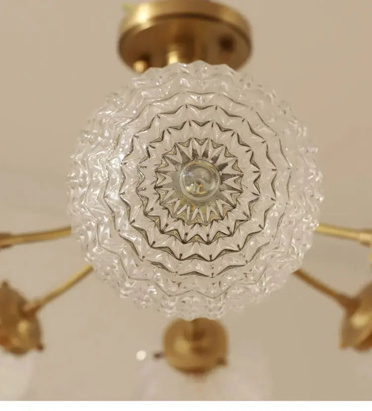 Clear intricately cut glass ball ceiling light with brass-finished frame by DecorBites for modern living spaces