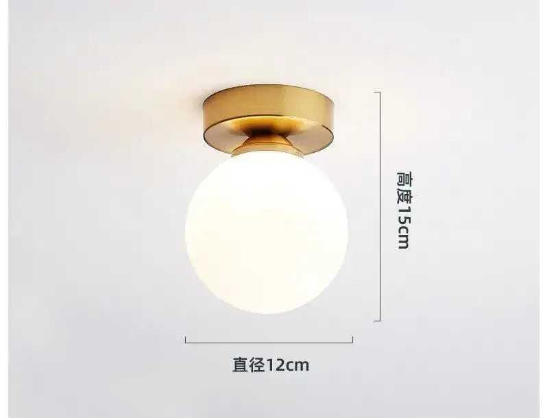 A decorbites glass ball ceiling light with a brushed gold metal base and frosted white glass globe in modern nordic style