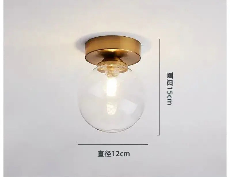 DecorBites glass ball ceiling light with clear glass globe and brass base measuring 15cm height and 12cm diameter