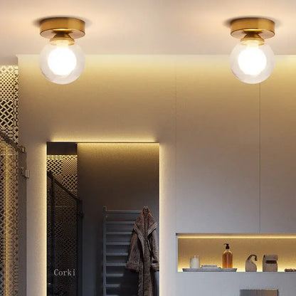 Two brass-finished decorbites glass ball ceiling lights with frosted glass globe shades for modern home decor
