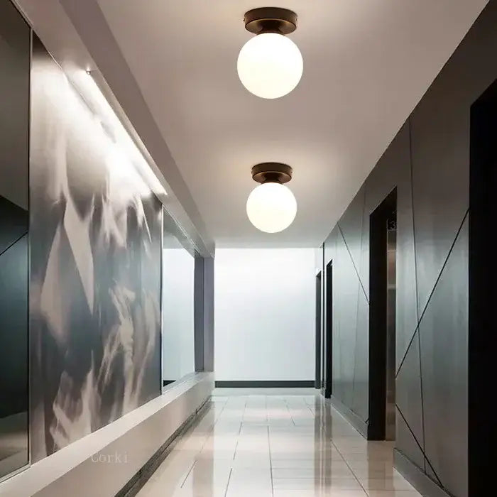Two round frosted glass globe ceiling lights with dark bronze fixtures from decorbites glass ball ceiling collection