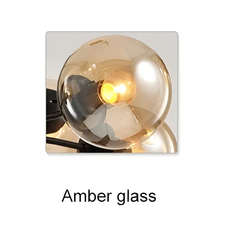 Amber glass globe with warm glowing light in DecorBites glass ball chandelier black Art Deco pendant lighting for dining room