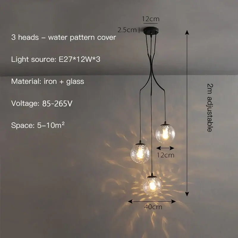 Decorbites glass ball chandelier ceiling pendant in black iron and glass with three spherical bulbs casting a water pattern