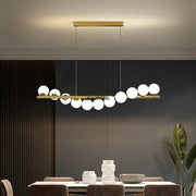 Gold-toned decorbites glass ball chandelier with sleek horizontal bar and spherical glass bulbs for dining room or kitchen