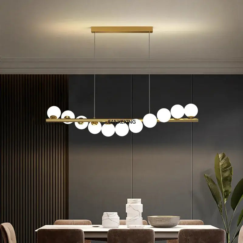 Gold-toned decorbites glass ball chandelier with sleek horizontal bar and spherical glass bulbs for dining room or kitchen