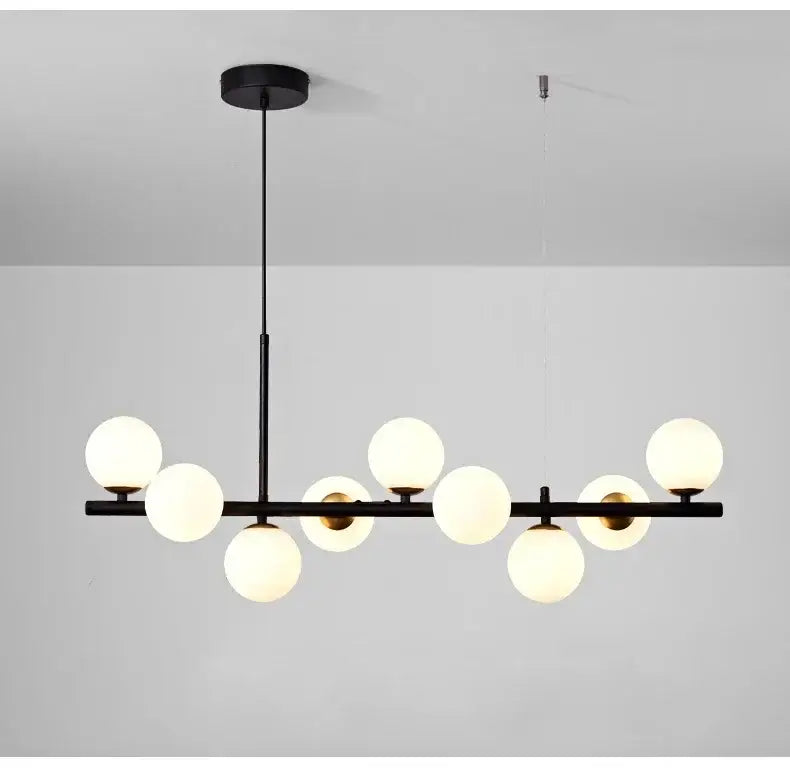 Black DecorBites™ glass ball chandelier with nine frosted glass globes arranged horizontally for home lighting