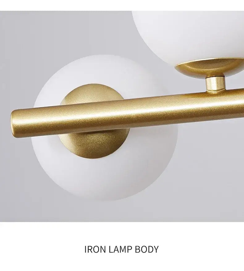 Gold-finished iron decorbites glass ball chandelier with cylindrical rods and frosted white spherical glass shades