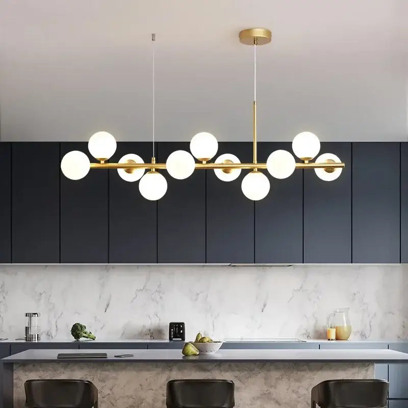 Decorbites™ glass ball chandelier featuring gold-toned pendant light with multiple white glass ball bulbs in linear design