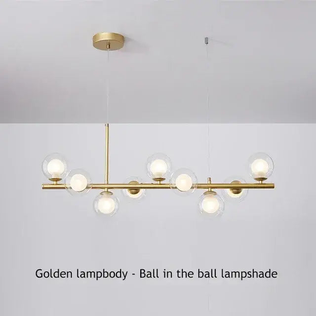 Golden glass ball chandelier with spherical glass shades housing illuminated bulbs for home lighting by decorbites