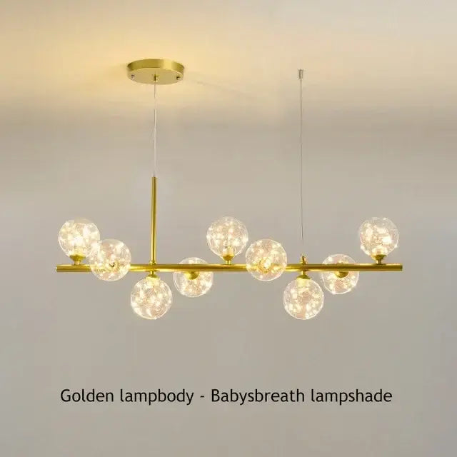 DecorBites™ glass ball chandelier with golden finish and spherical glass lampshades emitting warm glow for home lighting