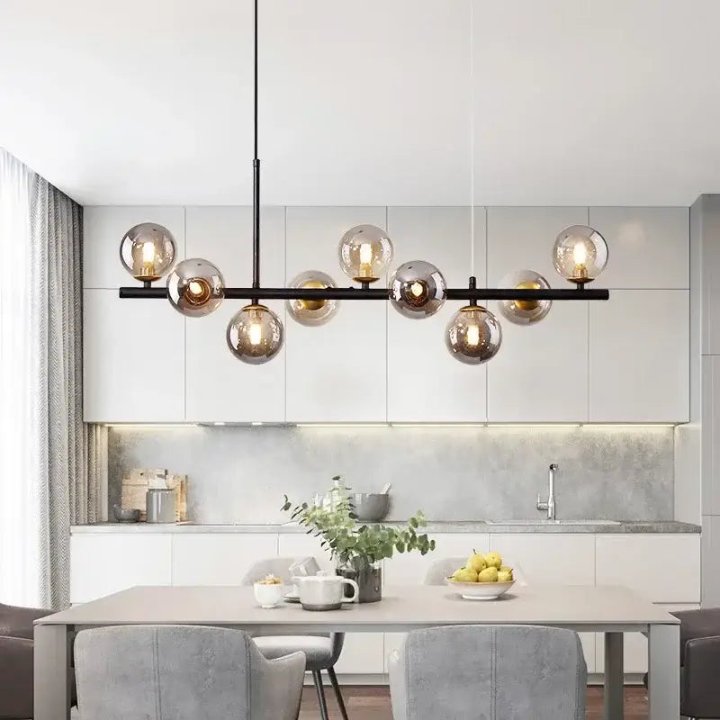 Modern black metal decorbites™ glass ball chandelier with multiple spherical glass bulbs emitting warm glow for home lighting