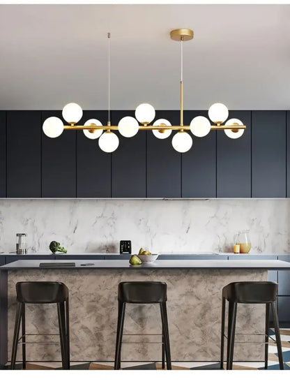 Modern gold-toned DecorBites™ glass ball chandelier with multiple white glass bulbs in a linear ball chandelier design