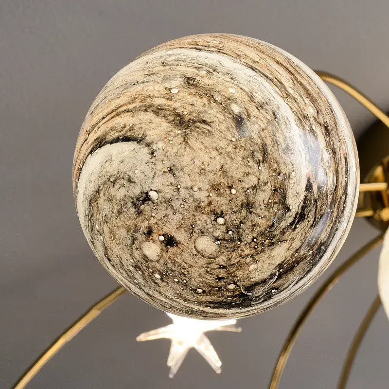 A decorbites glass ball chandelier featuring a marbled glass ball with beige, brown, and black patterns for kids room and living room
