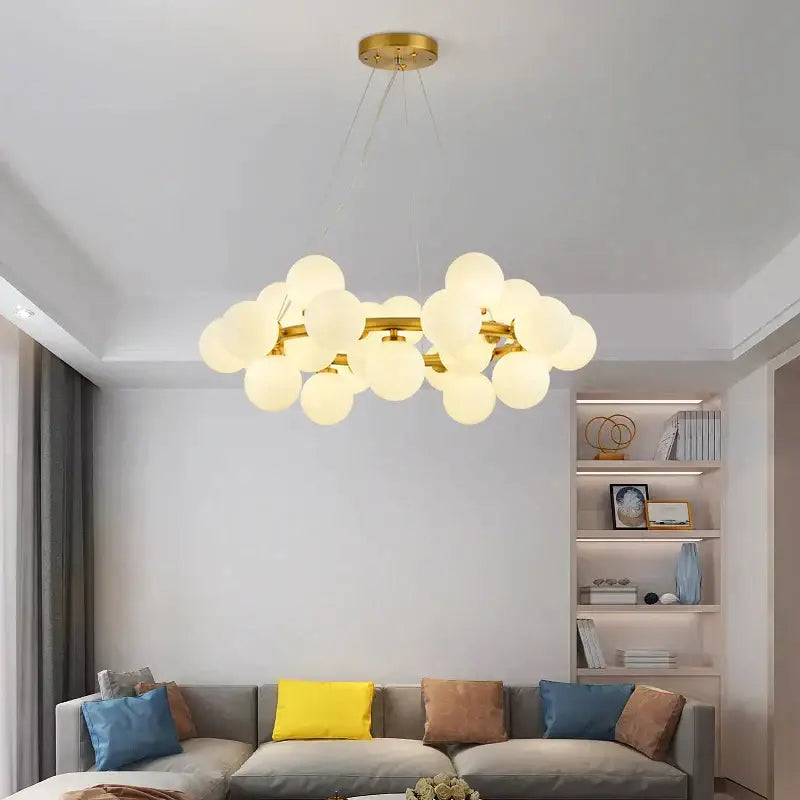 Gold-toned decorbites glass ball chandelier with frosted glass globes for modern living room and kitchen island lighting