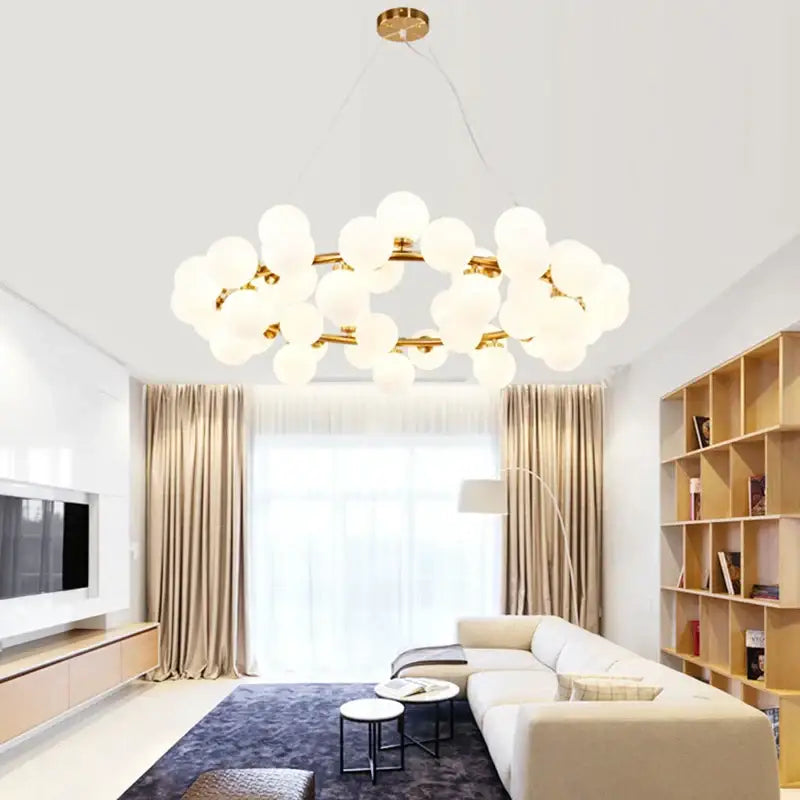 Gold-toned decorbites glass ball chandelier with frosted globe bulbs in modern cluster design for living room