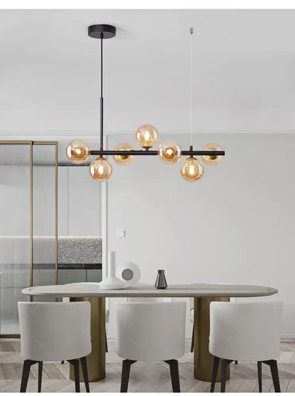 Modern black metal glass ball chandelier with warm amber glass globe bulbs for elegant ball ceiling lighting