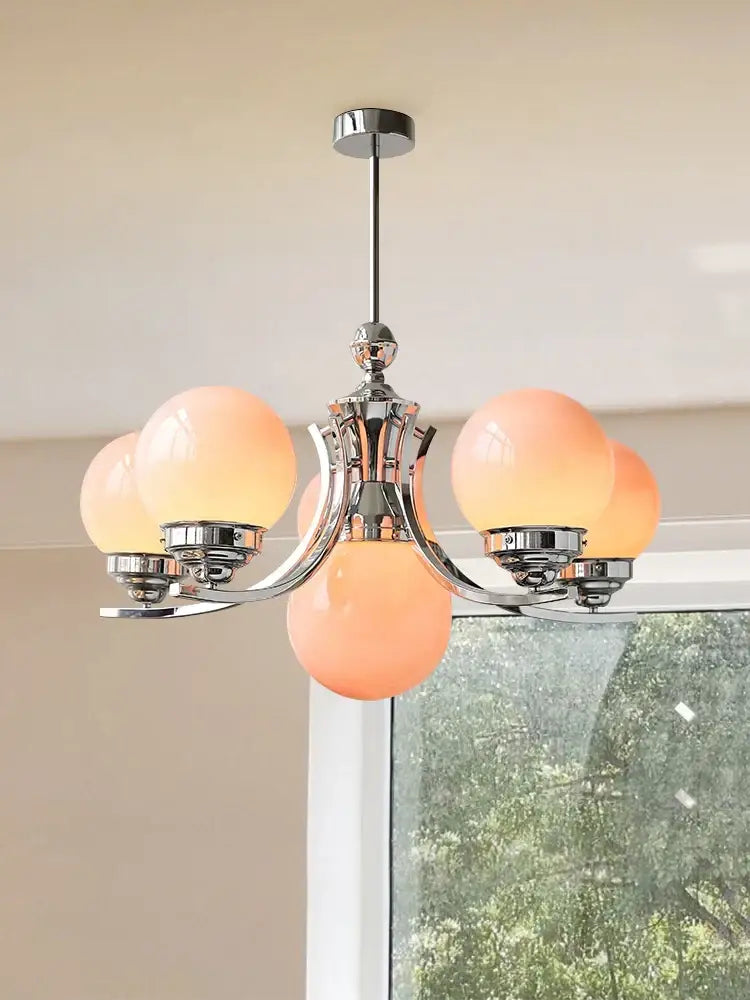 Chrome-finished decorbites glass ball chandelier with five frosted peach glass globe shades for modern room decor