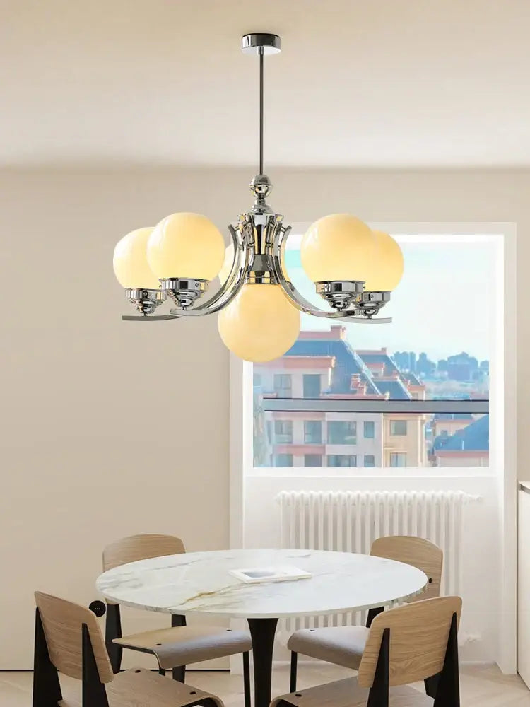 Chrome-finished decorbites glass ball chandelier with five warm frosted glass globe shades for modern room decor
