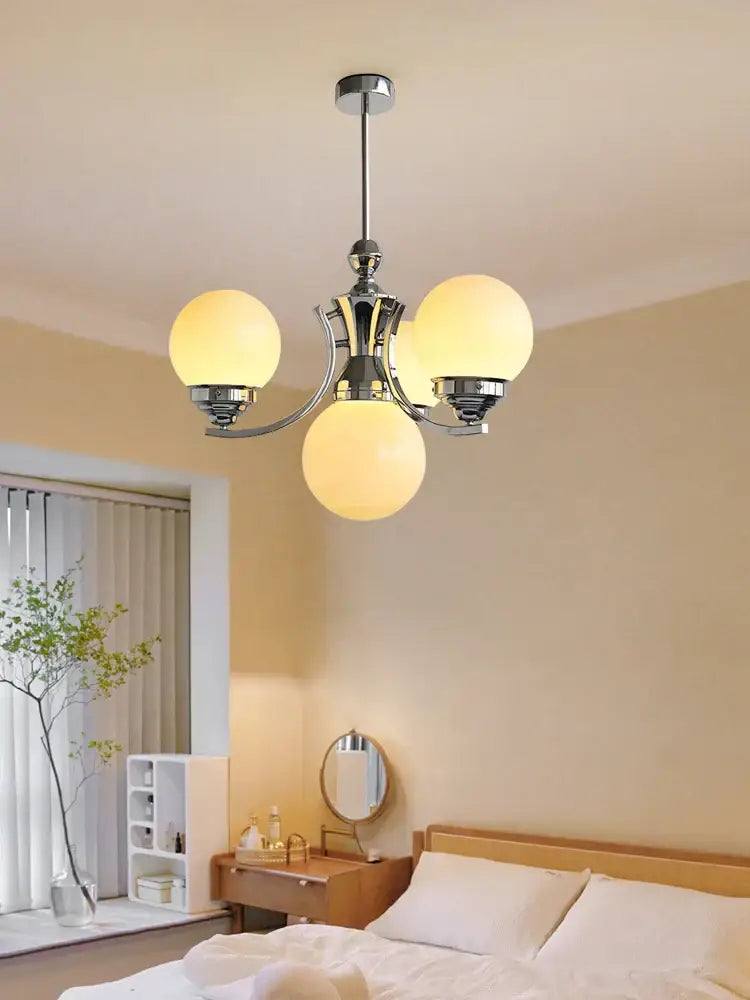 Chrome-finished decorbites glass ball chandelier with three warm glowing spherical glass shades for modern room decor