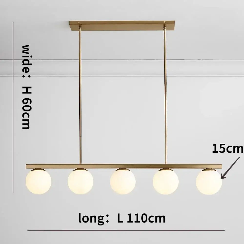 Modern brass-finished pendant light featuring five frosted glass bulbs in a linear decorbites glass ball chandelier design