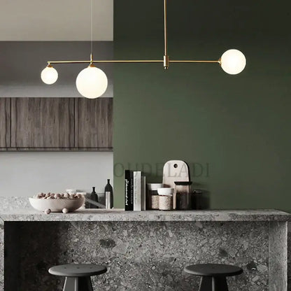 Gold-toned decorbites glass ball pendant light fixture with three frosted glass globe bulbs for dining room lighting