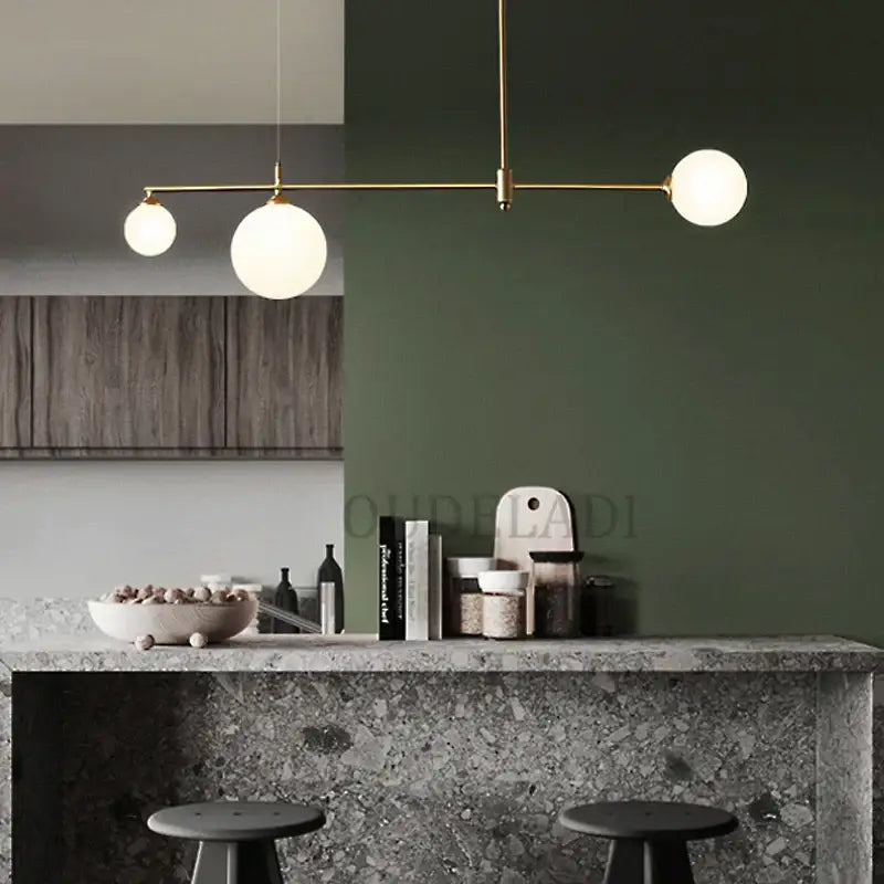 Gold-toned decorbites glass ball pendant light fixture with three frosted glass globe bulbs for dining room lighting