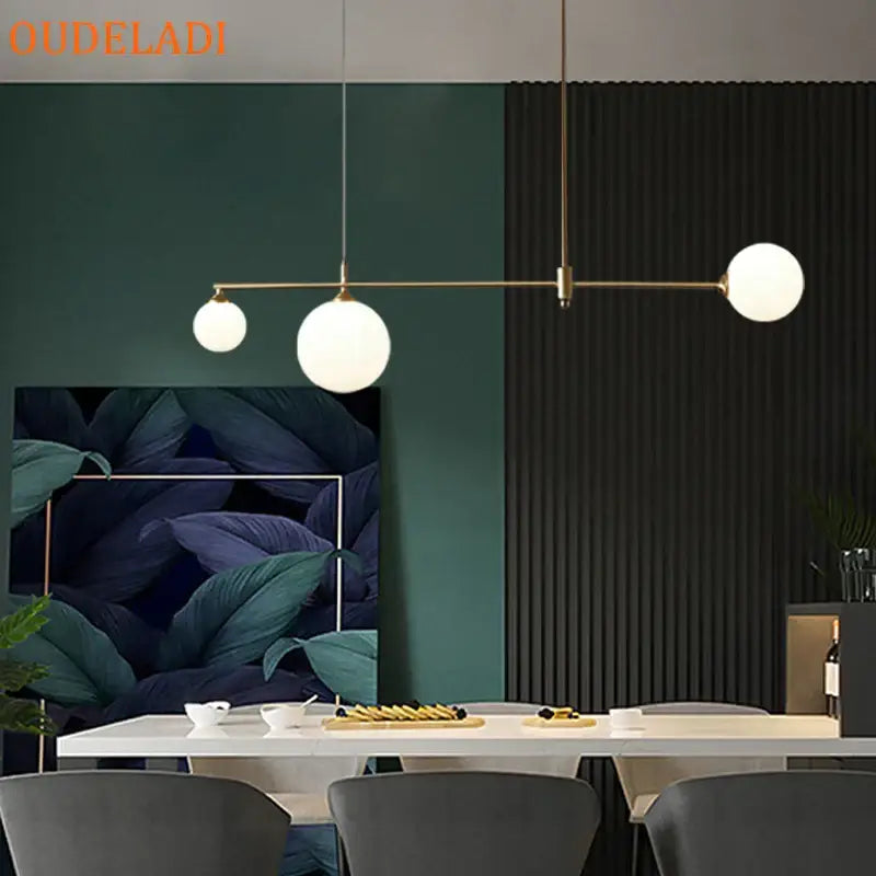 Modern brass pendant light fixture with three frosted glass globe bulbs by DecorBites glass ball for dining room use