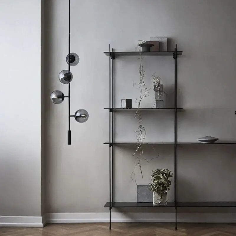 Black metal shelf with glass shelves and minimalist design paired with decorbites glass ball chandelier pendant light