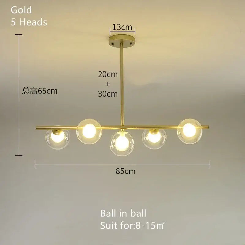 Gold-colored modern decorbites glass ball chandelier with five spherical glass bulbs in a linear LED pendant design