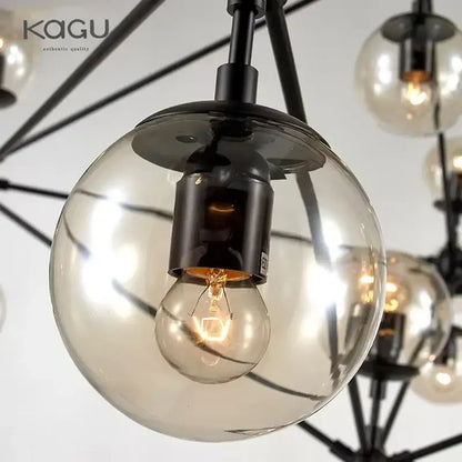 A modern decorbites glass ball chandelier with black metal frames and spherical glass globes featuring filament bulbs