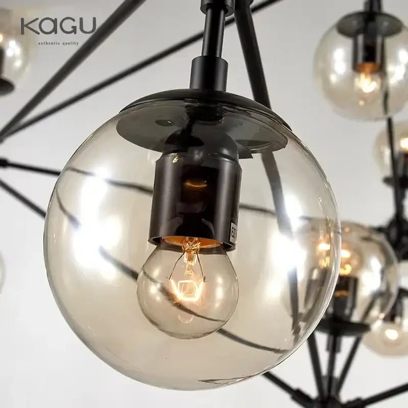 A modern decorbites glass ball chandelier with black metal frames and spherical glass globes featuring filament bulbs