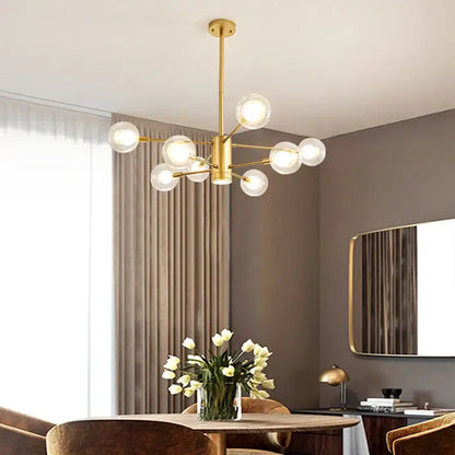 Gold-toned decorbites glass ball chandelier with multiple clear glass globe bulbs for modern lighting decor