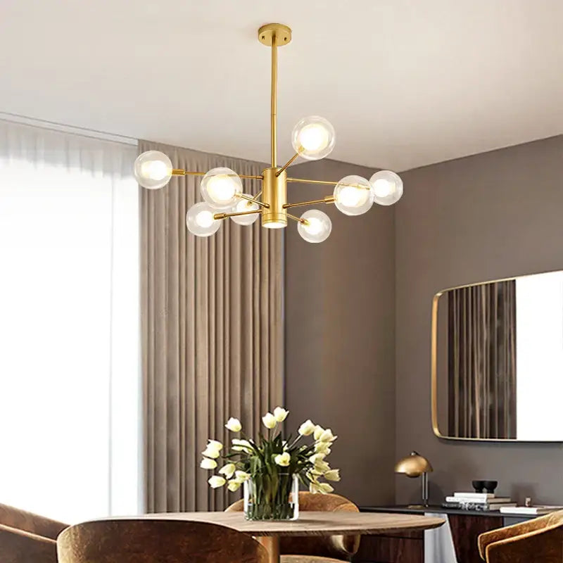 Gold-toned decorbites glass ball chandelier with multiple clear glass globe bulbs for modern lighting decor