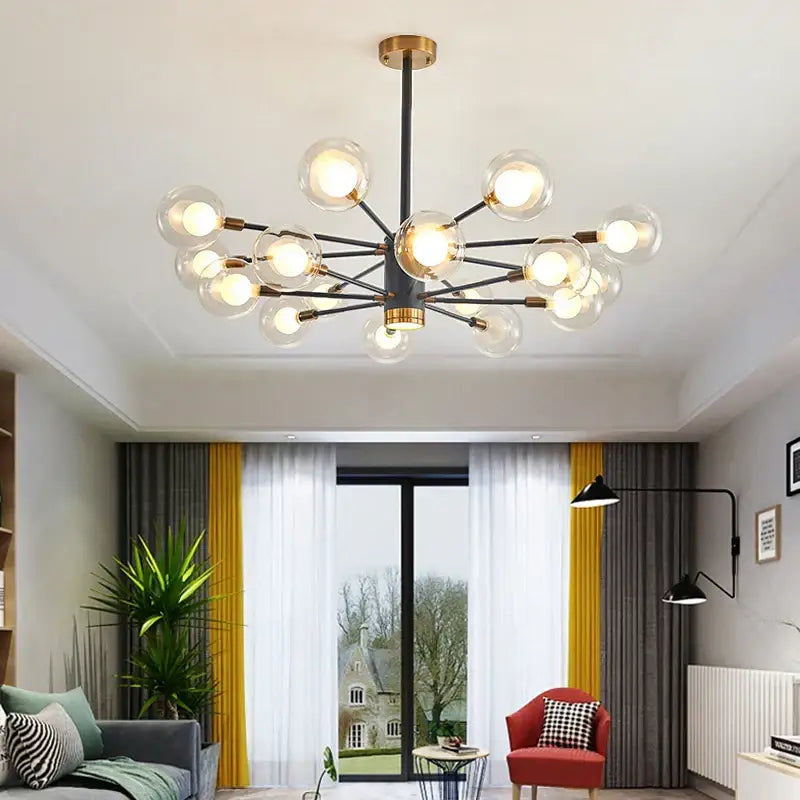 Modern decorbites glass ball chandelier with black metal frame gold accents and clear glass globe bulbs in an organic design