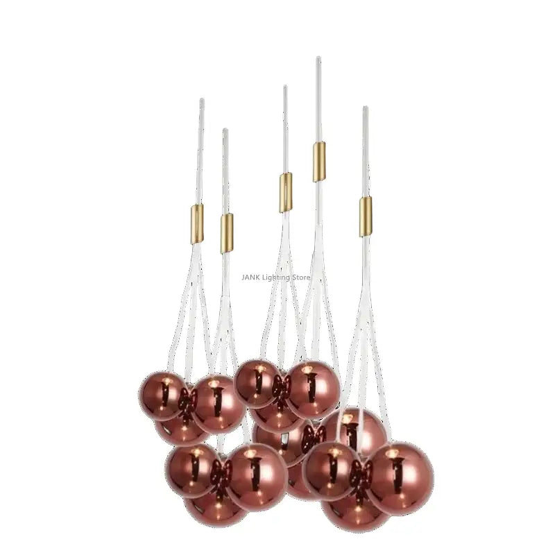 A decorbites glass ball chandelier featuring rose gold metallic spherical ornaments with brass connectors and white cords