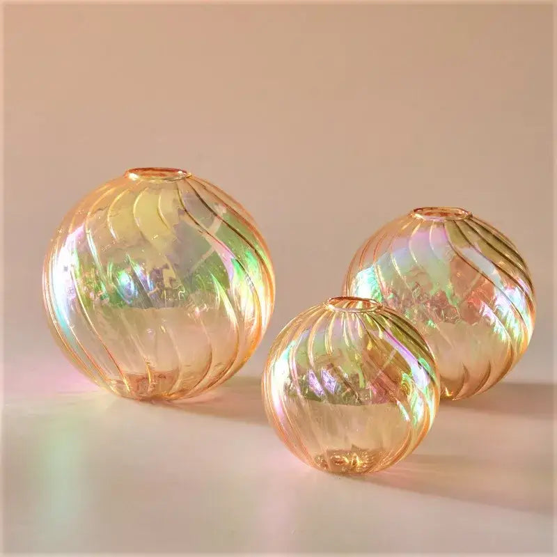 Iridescent peach-colored glass ball vases with swirling ribbed patterns in a DecorBites™ home decor vase set