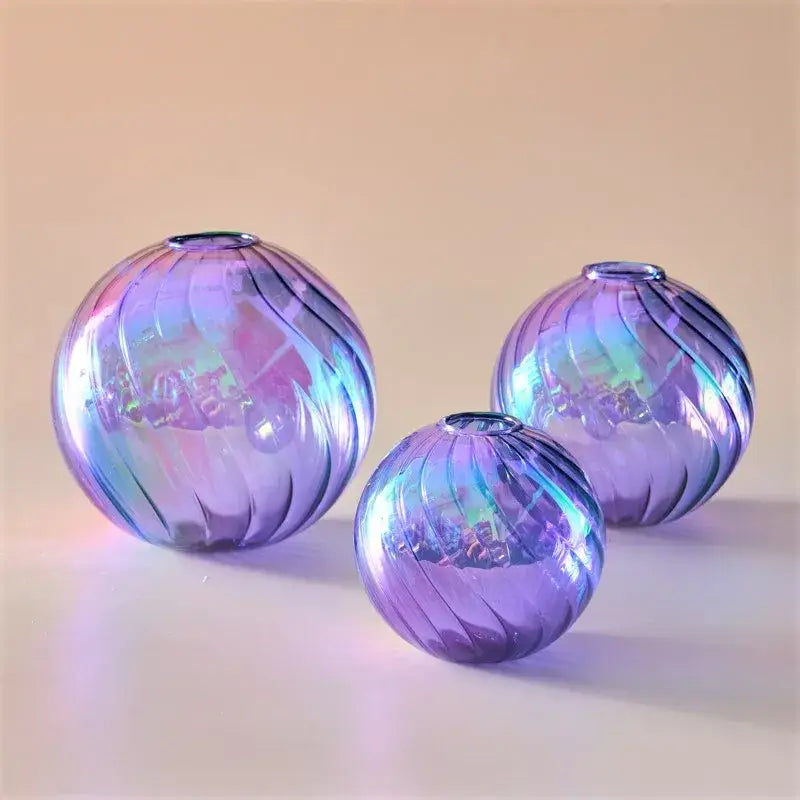 Three iridescent purple glass spheres with swirling ribbed patterns in decorbites™ ball vases set for home decor