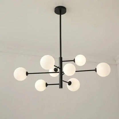 Modern black metal decorbites glass brass chandelier with frosted white spherical globes for living room lighting