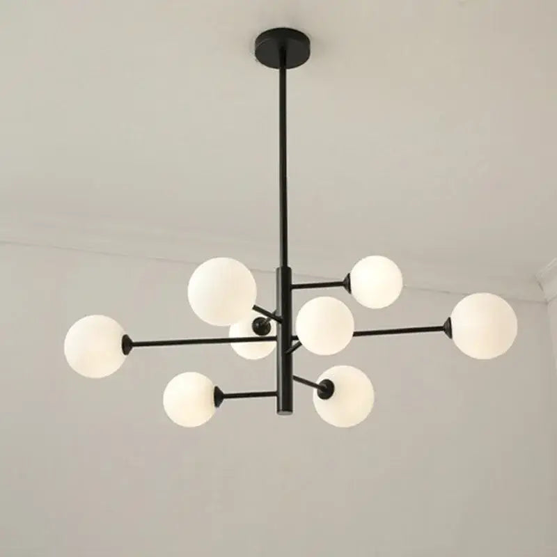 Modern black metal decorbites glass brass chandelier with frosted white spherical globes for living room lighting