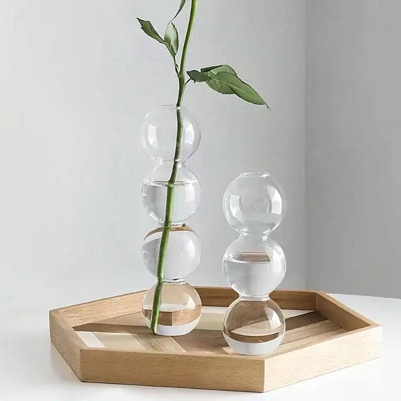 Decorbites glass bubble hydroponic vase made of clear glass with stacked spheres holding a single green rose stem