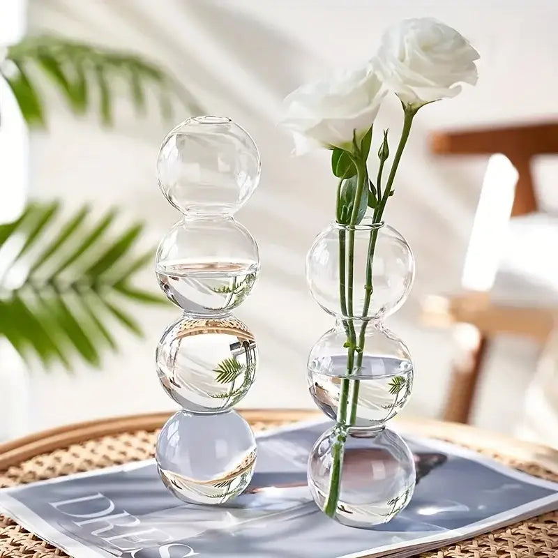 Clear glass bubble hydroponic vase with stacked spheres holding a single white rose for wedding and home decor