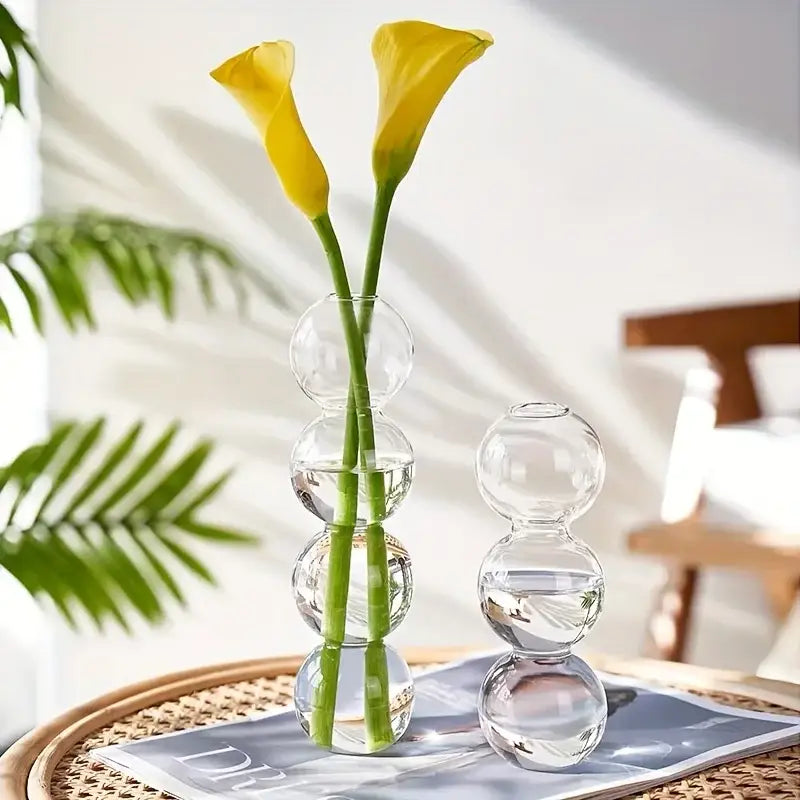 Decorbites glass bubble hydroponic vase with stacked spherical glass segments holding two yellow calla lilies for wedding and home