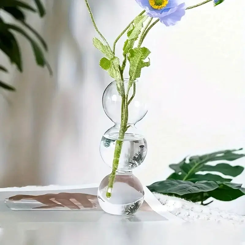 Decorbites glass bubble hydroponic vase with three stacked clear glass spheres holding a light purple flower