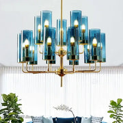 Decorbites glass chandelier featuring blue glass cylinders and gold-toned metal arms for luxury dining rooms