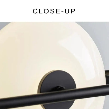 Cream-colored glossy glass chandelier with black metal frame and circular base from decorbites glass chandelier collection
