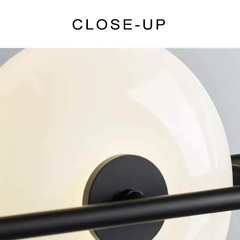 Cream-colored glossy glass chandelier with black metal frame and circular base from decorbites glass chandelier collection