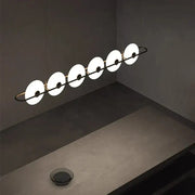 Modern minimalist decorbites glass chandelier with five white diffusers on black metal frame in store exhibition setting