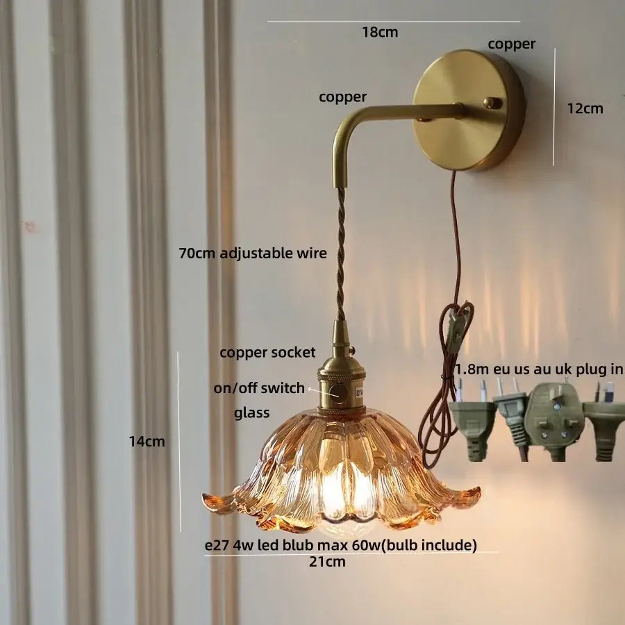 A warm amber glass flower led wall sconce with copper green flower metal hardware and pull chain by decorbites